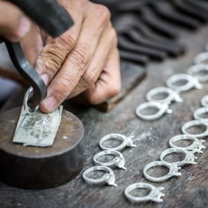Thai jeweler, handles the jewelry and precious stones in the workshop, the process of jewelry making ,close-up